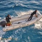 The crew getting ready to tie the boat up for the night from a Zodiac